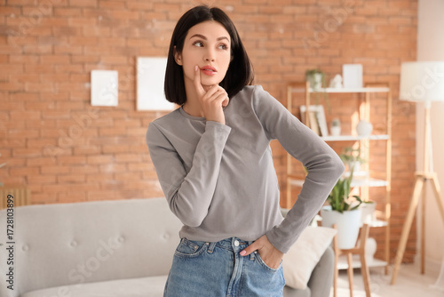 Thoughtful young woman at home