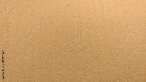 Background of brown kraft paper or cardboard texture. Abstract pattern of beige rough carton, old paper sheet.