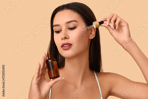 Young woman applying facial...