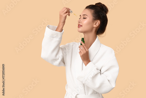 Young woman applying facial...
