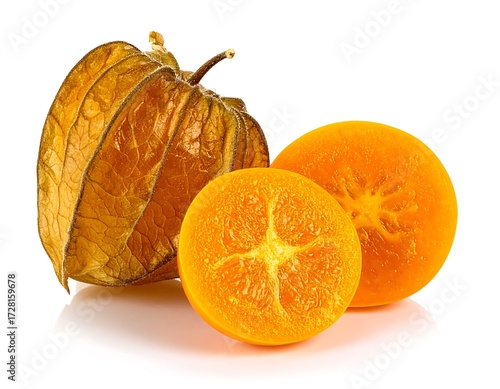 Close-up of a dried physalis fruit and segments of a citrus fruit