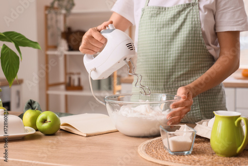 Woman whipping egg whites w...