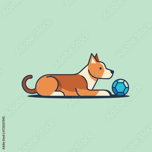 Dog lying next to a blue soccer ball on a green background  
