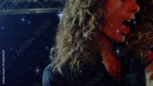 Music singer gripping mic, unleashing notes emotionally with starfield and revealing keyboardist