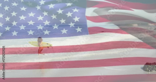 Flag overlay fading woman surfer carrying yellow board entering waves paddling out for travel