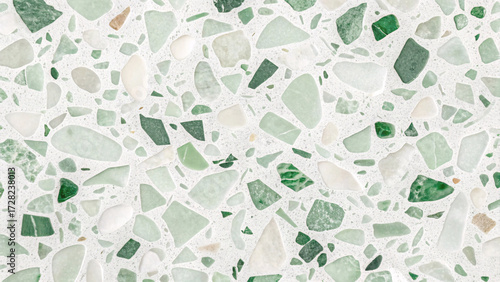 Mixed green terrazzo pattern with jade, emerald, and white stone fragments creating natural mosaic in polished concrete flooring.