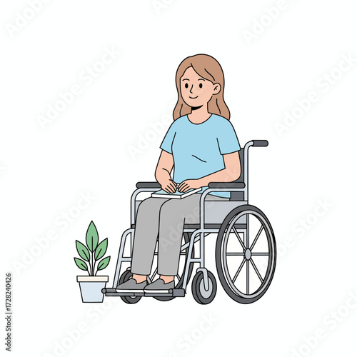 A happy, positive young woman holding a book sits in a wheelchair next to a small potted plant.