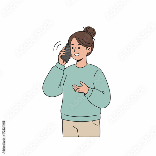 A happy, smiling woman with her hair in a bun is having a pleasant conversation on her mobile phone.