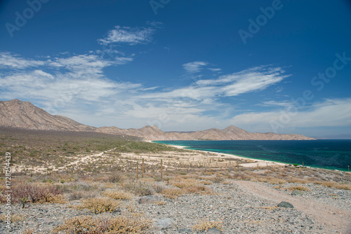 La Paz Baja California Sur Mexico, Seascape of the beach El Muerto or Ensenada de Muertos with view of the sea of ​​Cortes and mountains in the background with blue and sunny sky and clouds 