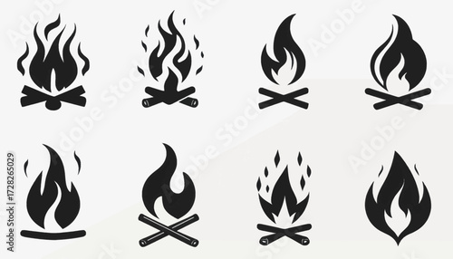 Collection of eight stylized black and white campfire icons with flame and wood log designs.
