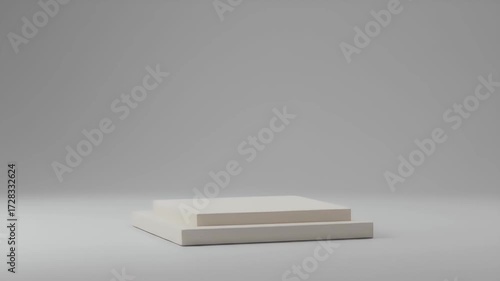 Minimalist off-white tiered platform against a neutral background, shallow depth