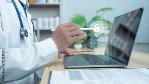Doctor using laptop with digital security lock icons, representing patient data protection, healthcare cybersecurity, HIPAA compliance, and secure medical information system.