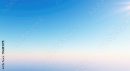 Vibrant sunrise paints the sky with soft pastel hues, casting a warm glow over a tranquil horizon, evoking peace and new beginnings for a fresh day.