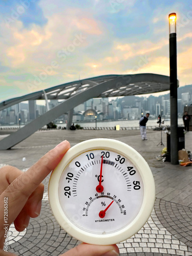 cold winter fall season 18 celsius temperature thermometer on hand avenue of stars park waterfront walk promenade handprints plaques Hong Kong stars bridge in kowloon tsim sha tsui china