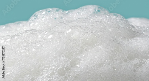 Captivating close-up reveals delicate white soap bubbles shimmering with light against a serene blue background, perfect for conveying purity, freshness, and clean living.
