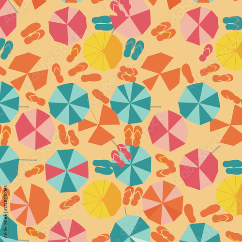 Beach umbrella and flip-flop pattern on sand from high angle. Colorful umbrellas and flip-flops are spread on a beige sandy surface.
