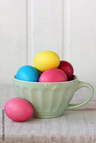 Colorful easter eggs in a ceramic cup celebrating spring holiday