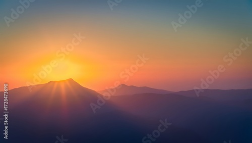 Sunrise over mountains casting long shadows with a vibrant orange and blue sky view 90