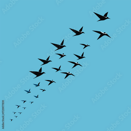 A flock of birds flying diagonally across a blue sky, creating a sense of freedom and movement in nature