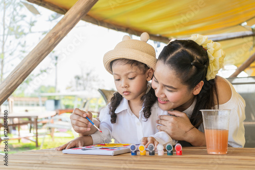 Asian mother and daughter draw people.