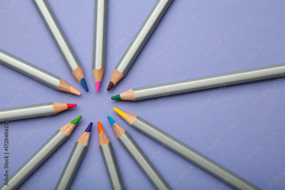 Fototapeta premium Many colorful pencils on purple background. Space for text