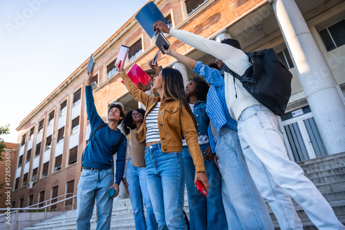 Photos Diverse student friends celebrating success at university campus