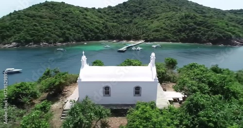 Scenic coastal view featuring a white chapel by the sea