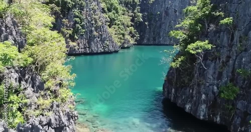 Serene turquoise lagoon surrounded by rocky cliffs