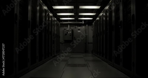 Server room with rows of cabinets and glowing lights