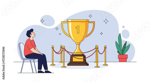 A person sits in a chair looking up at a large golden trophy.