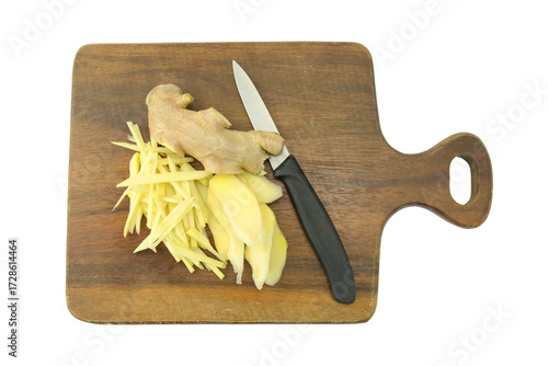 cutting board with a knife on a cutting board, Fresh ginger root with skin and peel sliced on cutting board with black handle knife isolated on white background top view flat lay stack