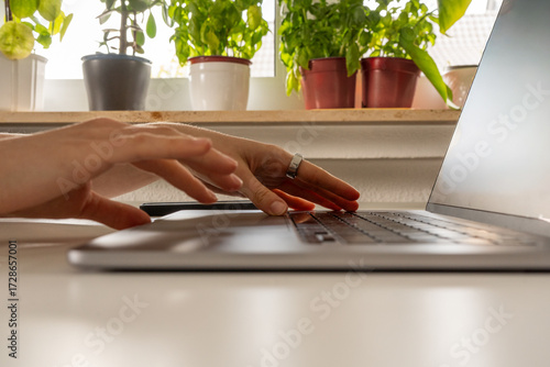 Close up of using laptop keyboard and touchpad, Hands in motion with smart ring on the finger