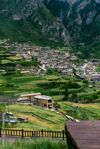 Wooden plank road in the town among the green mountains