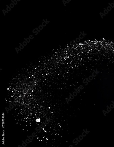 Particles in motion against black background