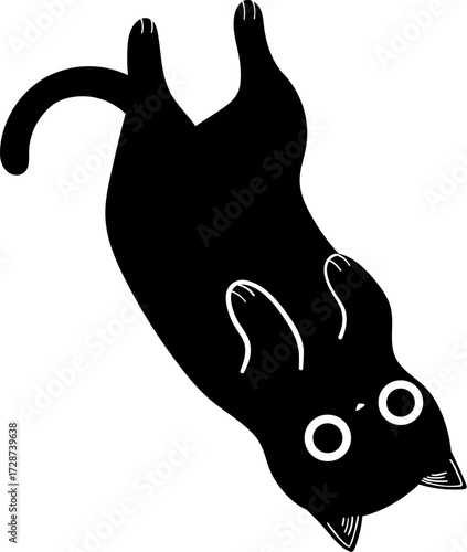 A black cat is upside down with its paws in the air