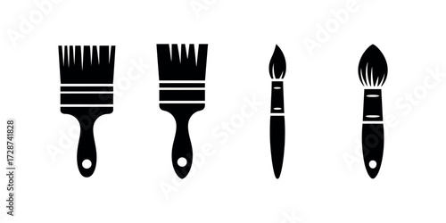 Collection of black paintbrushes with different brush heads on a white background