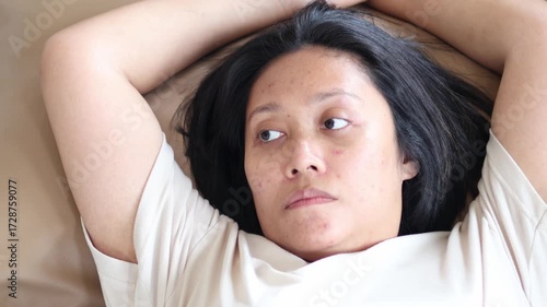 Asian woman face looks stressed, sad, and unhappy.