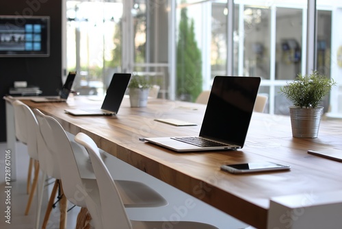 Wallpaper Mural Modern office workspace with laptops and wooden meeting table. Torontodigital.ca