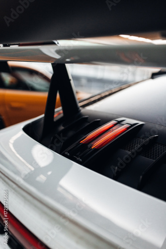 Big carbon spoiler wing on the trunk of modern supercar