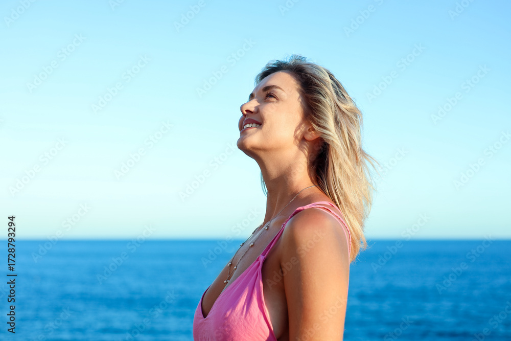 Naklejka premium Happy woman near sea on summer day