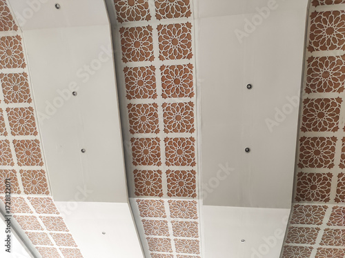 Textured mosque ceiling and ceramic ornaments. The beauty of a Muslim place of worship. Ornamental decorations that fill the ceiling. Wallpaper backgrounds. Interior decoration references.