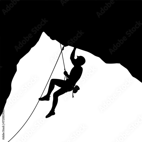 Silhouette of a determined rock climber rappelling down a challenging mountain cliff face