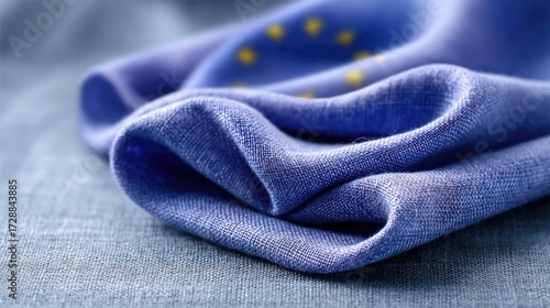 Detailed View of European Union Flag on Textured Fabric with Gold Stars and Blue Textile Backdrop