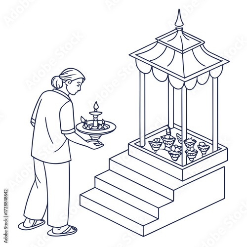 A woman in traditional attire carries a lamp to illuminate a tiered structure adorned with multiple lamps symbolizing devotion and cultural rituals