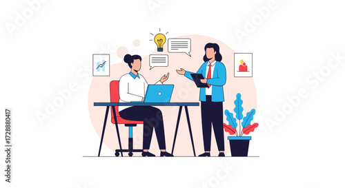 Two people collaborating on a project at a desk with a laptop and plant.