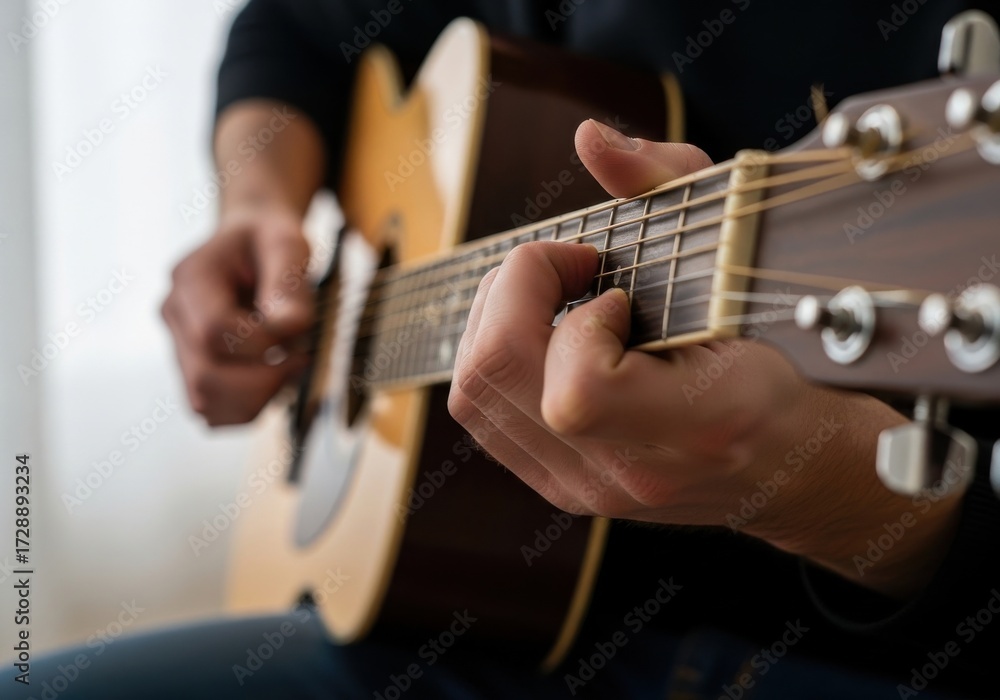 Fototapeta premium Close-up of person playing acoustic guitar