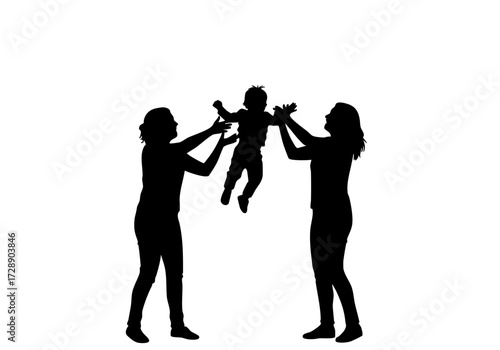 Silhouette of mother and daughter playing with their baby, tossing him into the air with joy.