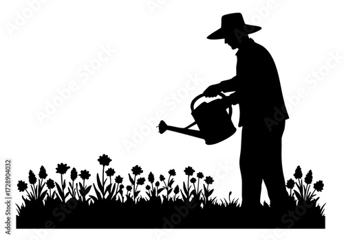 Gardener silhouette watering flower bed in the sunlight.