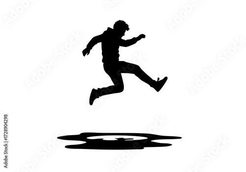 A silhouetted figure jumps boldly over a puddle.