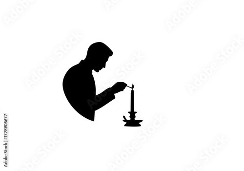 A silhouette of a person lighting a candle.